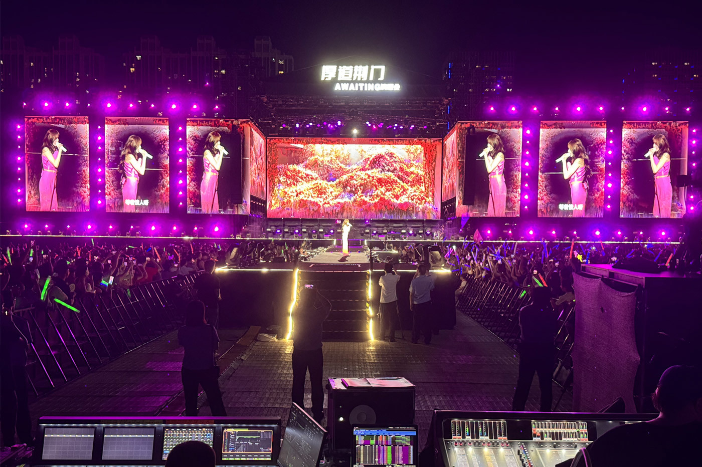 Multiple LED screens at a large outdoor concert